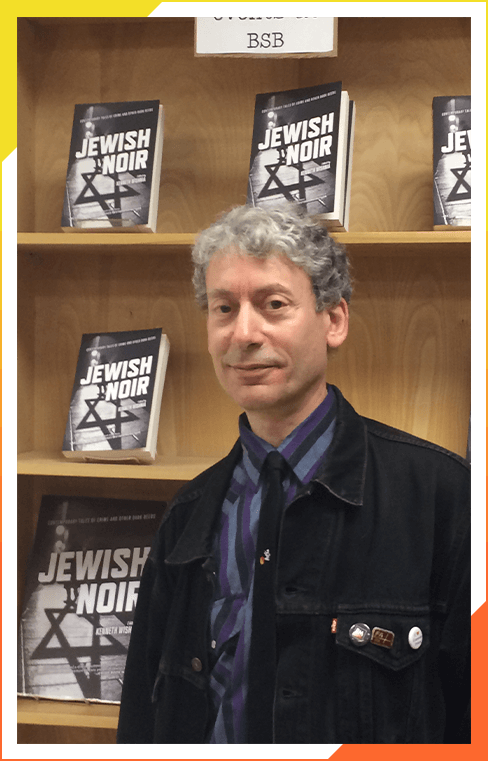 A man standing in front of some books.